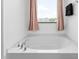 Soaking tub with chrome fixtures and privacy window at 413 Hallie Long Ln, Burlington, NC 27217