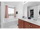 Bathroom featuring a large soaking tub, double vanity, and natural light at 413 Hallie Long Ln, Burlington, NC 27217