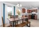 Inviting dining area with a rustic wood table, bench seating, and a view to the backyard at 413 Hallie Long Ln, Burlington, NC 27217