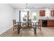 Cozy dining area featuring a wooden dining table, updated lighting, and access to the outdoor patio at 413 Hallie Long Ln, Burlington, NC 27217