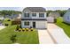 Charming home with manicured lawn, vibrant landscaping, and a welcoming front entrance at 413 Hallie Long Ln, Burlington, NC 27217