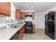 Modern kitchen featuring stainless steel appliances, sleek countertops, and ample cabinet space at 413 Hallie Long Ln, Burlington, NC 27217