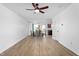 Open-concept living and dining area with wood-look floors and natural light, ideal for entertaining at 413 Hallie Long Ln, Burlington, NC 27217