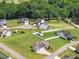 Aerial perspective displays residences nestled within a mature tree canopy, showcasing community layout and landscaping at 50 N Nolan Park Dr, Selma, NC 27576