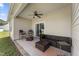 Covered back patio with comfortable seating, ceiling fan, and sliding door access to the house at 50 N Nolan Park Dr, Selma, NC 27576