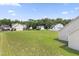 Extensive backyard space surrounded by lush trees and neighboring homes, perfect for creating a private retreat at 50 N Nolan Park Dr, Selma, NC 27576