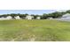 Large, grassy backyard with plenty of room for activities and gardening, surrounded by neighboring homes at 50 N Nolan Park Dr, Selma, NC 27576