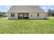 Spacious backyard featuring a well-maintained lawn and a covered porch, perfect for outdoor relaxation and entertaining at 50 N Nolan Park Dr, Selma, NC 27576