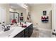 Bathroom with a double sink vanity, a large framed mirror, and a walk-in shower with glass door at 50 N Nolan Park Dr, Selma, NC 27576