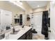 Bathroom with a modern vanity, granite countertops, a framed mirror, and a walk-in shower with black trim at 50 N Nolan Park Dr, Selma, NC 27576
