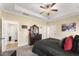 Bedroom with trey ceiling, ceiling fan, and large dresser, and bed with decorative pillows at 50 N Nolan Park Dr, Selma, NC 27576