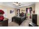 Bedroom showcasing a trey ceiling, ceiling fan, and a bed with decorative pillows, curtains, and artwork at 50 N Nolan Park Dr, Selma, NC 27576