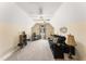 Spacious bonus room featuring a comfortable black sofa, desk, and a ceiling fan at 50 N Nolan Park Dr, Selma, NC 27576