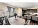 Dining room shows a large table with a gray cloth, gray chairs, and views to the kitchen at 50 N Nolan Park Dr, Selma, NC 27576