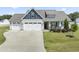 Charming home with a spacious three-car garage and well-maintained front yard at 50 N Nolan Park Dr, Selma, NC 27576