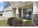 Charming front porch with rocking chairs, stone accents, and well-maintained landscaping at 50 N Nolan Park Dr, Selma, NC 27576