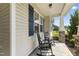 Covered porch with rocking chairs and stone accents, offering a cozy outdoor space at 50 N Nolan Park Dr, Selma, NC 27576