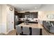 Bright kitchen with an island, stainless appliances and dark cabinetry with views to the living area at 50 N Nolan Park Dr, Selma, NC 27576