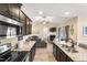Open kitchen with granite counters, black appliances and an island bar that overlooks the living room at 50 N Nolan Park Dr, Selma, NC 27576