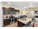 Well-lit kitchen with granite countertops, dark cabinets, and a center island with a sink at 50 N Nolan Park Dr, Selma, NC 27576