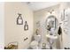 Elegant powder room featuring pedestal sink, decorative mirror, and stylish wall decor at 50 N Nolan Park Dr, Selma, NC 27576