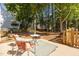 View of a backyard patio and yard with surrounding trees and partial view of the house at 513 Moultonboro Ave, Wake Forest, NC 27587