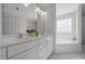 Bathroom with double vanity, soaking tub, tile floors, and lots of natural light at 513 Moultonboro Ave, Wake Forest, NC 27587