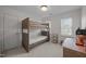 Cozy bedroom featuring a bunk bed, neutral carpet, and natural light from windows at 513 Moultonboro Ave, Wake Forest, NC 27587