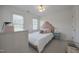 Cozy bedroom with a pink accent headboard, carpeted floors, and lots of natural light at 513 Moultonboro Ave, Wake Forest, NC 27587