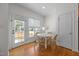 Bright breakfast nook with natural light, hardwood floors, and a view to the backyard at 513 Moultonboro Ave, Wake Forest, NC 27587