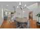 Spacious dining area with hardwood floors, featuring a staircase to the second floor and open layout at 513 Moultonboro Ave, Wake Forest, NC 27587