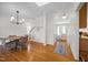 Bright dining area featuring hardwood floors, a modern chandelier, and staircase to the second floor at 513 Moultonboro Ave, Wake Forest, NC 27587