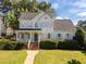 Charming two-story home featuring a covered front porch and well-manicured landscaping at 513 Moultonboro Ave, Wake Forest, NC 27587