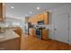 Eat-in kitchen with stainless steel appliances, wood cabinets, hardwood floors, and recessed lighting at 513 Moultonboro Ave, Wake Forest, NC 27587