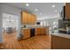 Kitchen with hardwood floors, wood cabinets, and views into the dining and living area at 513 Moultonboro Ave, Wake Forest, NC 27587