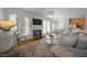 Comfortable living room featuring a fireplace, large windows, and an open layout to dining area at 513 Moultonboro Ave, Wake Forest, NC 27587