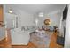 Open-concept living room with hardwood floors, neutral decor, fireplace, and plenty of natural light at 513 Moultonboro Ave, Wake Forest, NC 27587