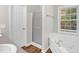 Bright bathroom featuring a shower, tub, and a large window, offering a spa-like experience at 514 Lipscomb Grove Church Rd, Hillsborough, NC 27278