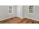 Well-lit bedroom featuring wood floors, neutral walls and trim, and a closet at 514 Lipscomb Grove Church Rd, Hillsborough, NC 27278