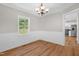 Bright dining room boasts stylish chandelier, wood flooring, and decorative wall trim at 514 Lipscomb Grove Church Rd, Hillsborough, NC 27278