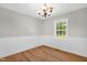 Bright dining room with modern flooring, elegant wainscoting, and a large window that brings in plenty of natural light at 514 Lipscomb Grove Church Rd, Hillsborough, NC 27278