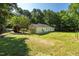 Detached garage with a large, grassy yard and mature trees at 514 Lipscomb Grove Church Rd, Hillsborough, NC 27278