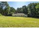 Back of home with large backyard, grassy area, and mature trees at 514 Lipscomb Grove Church Rd, Hillsborough, NC 27278