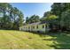 Back of home with large backyard, grassy area, and mature trees at 514 Lipscomb Grove Church Rd, Hillsborough, NC 27278