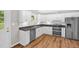 Modern kitchen featuring stainless appliances, white cabinets, and hardwood floors at 514 Lipscomb Grove Church Rd, Hillsborough, NC 27278