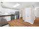 Spacious kitchen featuring modern stainless appliances, white cabinets, and hardwood floors at 514 Lipscomb Grove Church Rd, Hillsborough, NC 27278