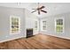 Spacious living room with modern floors, a cozy fireplace, and large windows that fill the room with natural light at 514 Lipscomb Grove Church Rd, Hillsborough, NC 27278