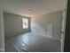Bedroom featuring a window, light walls, carpet, and a door leading to additional space at 5428 Jaeger Dr # 45, Graham, NC 27253