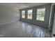 Clean bedroom with three windows and carpet that is covered with protective plastic at 5428 Jaeger Dr # 45, Graham, NC 27253