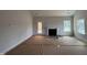 Unfinished living room features fireplace, windows, and access to outdoor space at 5428 Jaeger Dr # 45, Graham, NC 27253